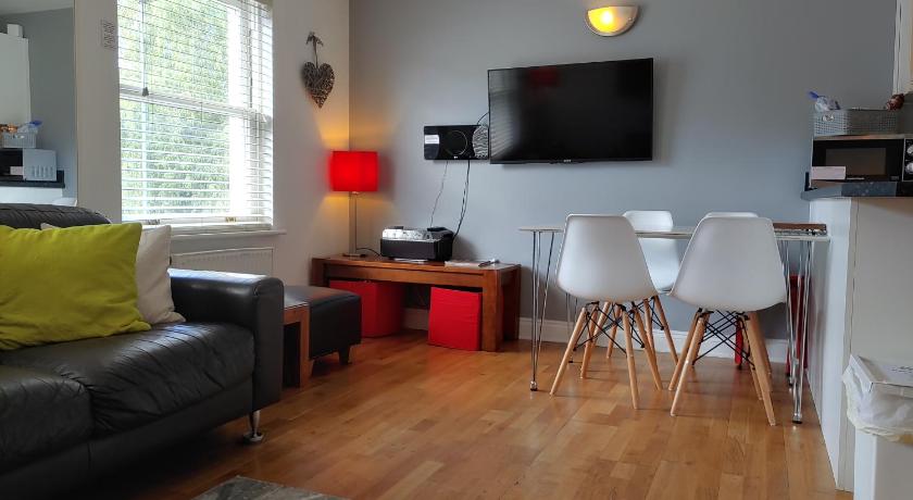 a living room filled with furniture and a tv, The Bath House Apartments - Free 1st breakfast - FREE parking in Bath