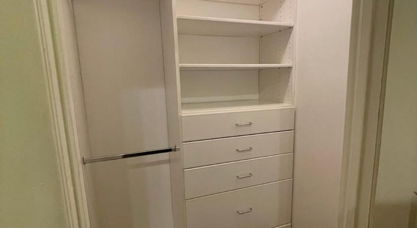 a room with a white cabinet and a white wall, Private Large LA Bedroom w Private Half-Bathroom - TV - AC - WIFI - Private Fridge near USC - Exposi in Los Angeles (CA)
