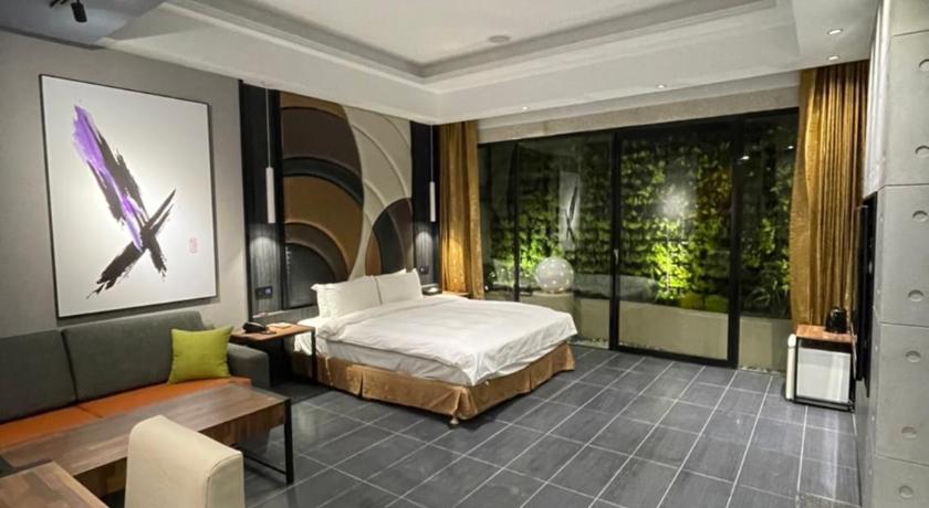 a large room with a large bed and a large window, Mini Malist Fashion Motel  in Taoyuan
