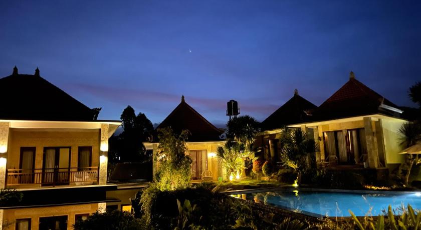 a hotel room with a balcony overlooking the ocean, Villa Danu in Bali