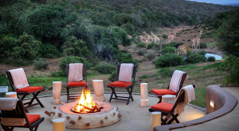 a table topped with chairs and a fire place, Safari Lodge - Amakhala Game Reserve in Paterson