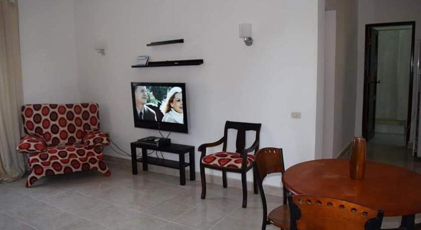 a living room filled with furniture and a tv, chalet Stella de Mari in Makadi Bey in Hurghada