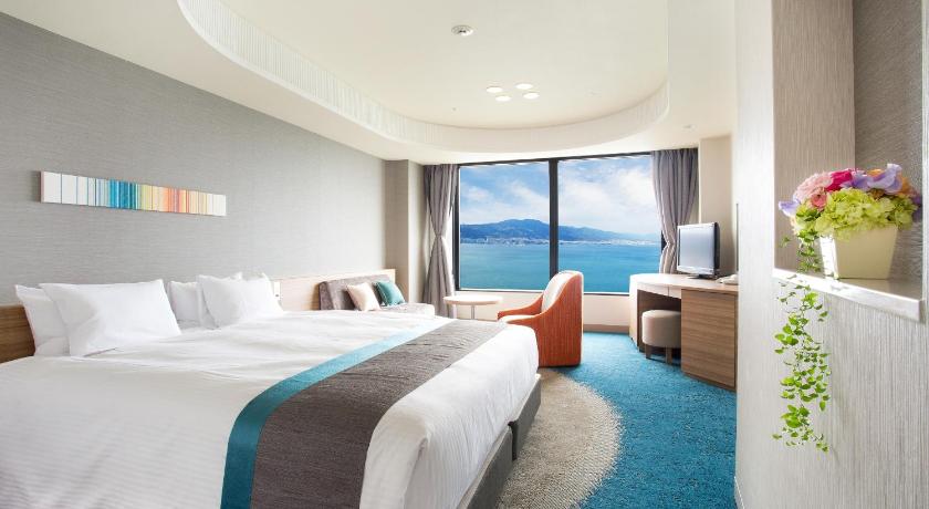 a hotel room with a large bed and a large window, Lake Biwa Otsu Prince Hotel in Otsu