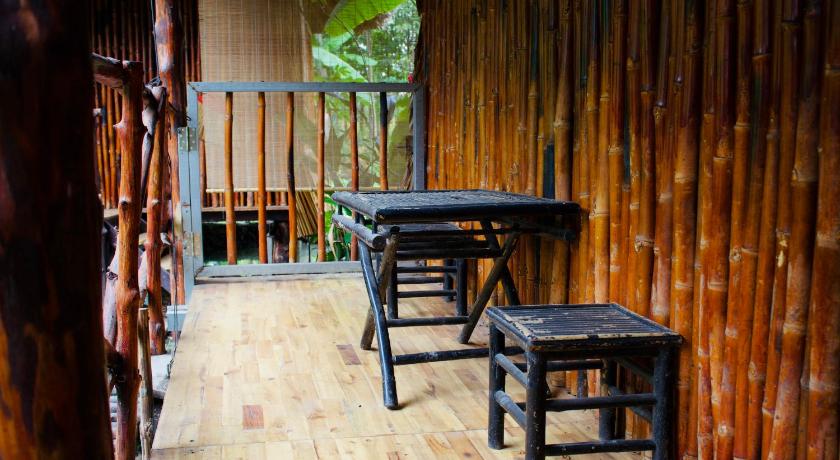 a row of wooden benches in a wooded area, Saigon Garden Homestay in Ho Chi Minh City