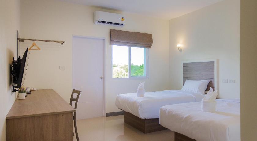a hotel room with two beds and a television, ONE Chumphon Hotel in Chumphon