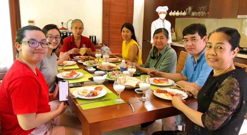 people sitting around a table eating food, The Ocean Luxury Villas by Danatrip in Đà Nẵng