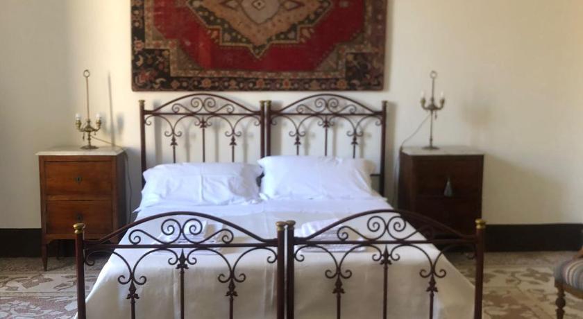 a bedroom with a bed and a dresser, Palazzo Bernardini Suites in Lecce