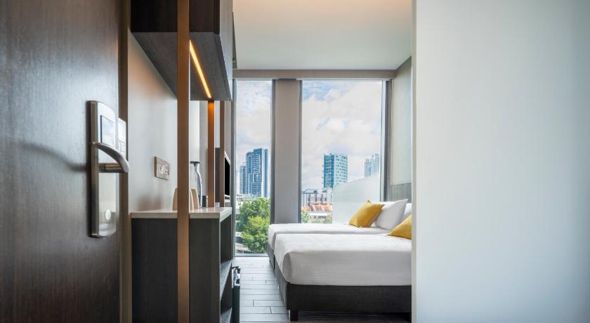 a bedroom with a white bed and white walls, Beverly Hotels Elements in Singapore