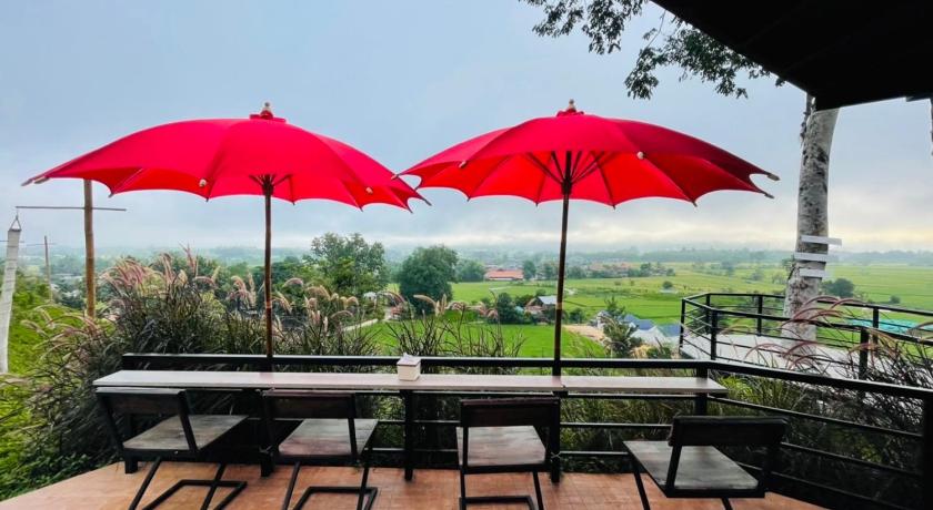 a patio area with tables and umbrellas, Pua Panorama Resort in Nan