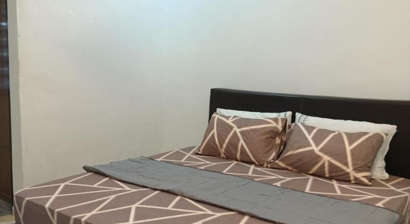 a bed with a white comforter and pillows, ADAMAYRAA HOMESTAY Tanah Merah in Tanah Merah