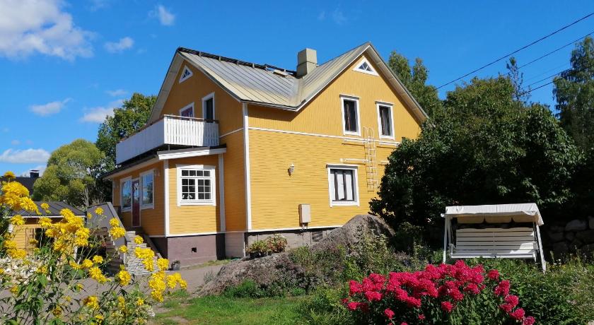 a house with a blue roof and a white house, Guesthouse Lokinlaulu in Kotka