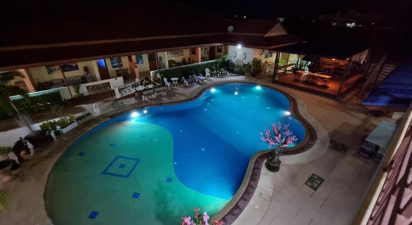 a swimming pool with a pool table and chairs, Baan Sabaijai Resort & Rehab in Nakhon Phanom