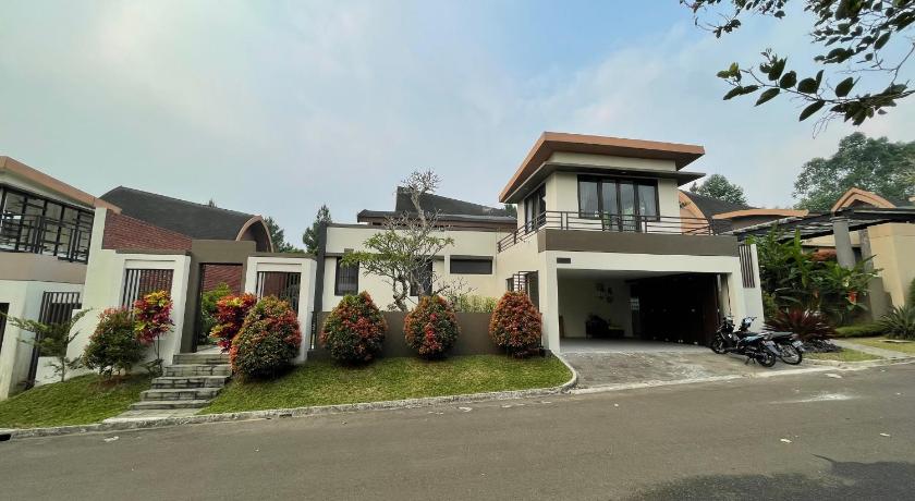 a large building with a lot of windows in front of it, Villa La Vimala in Puncak