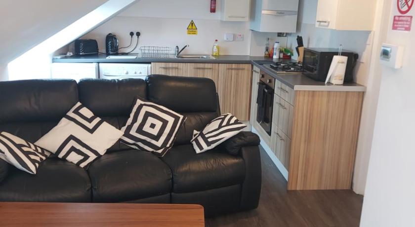 a living room with a couch and a coffee table, Maze Serviced Apartment in Ayr