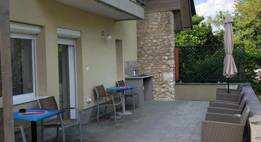 a patio area with a table and chairs, Juno Apartman Vendeghaz in Miskolc