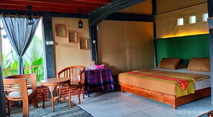 a bed room with two beds and a table, Ecobromo homestay in Bromo