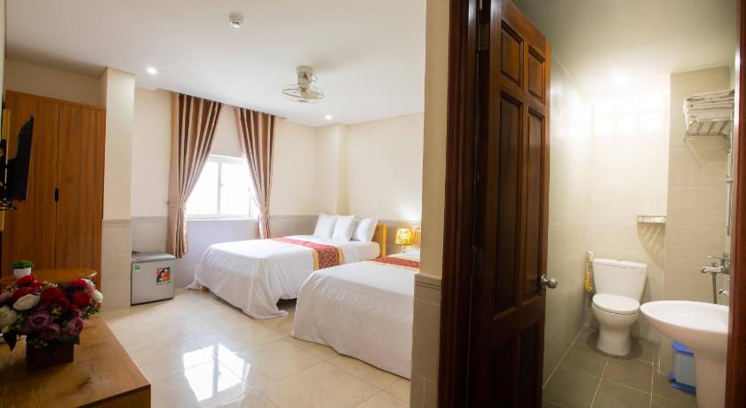 a hotel room with two beds and a toilet, California Hotel in Ho Chi Minh City