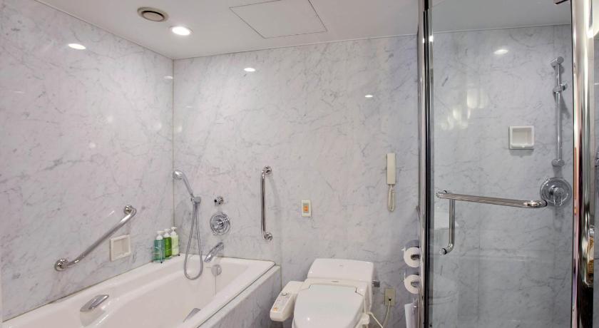 a bathroom with a toilet, tub, sink and shower, Nishitetsu Grand Hotel in Fukuoka