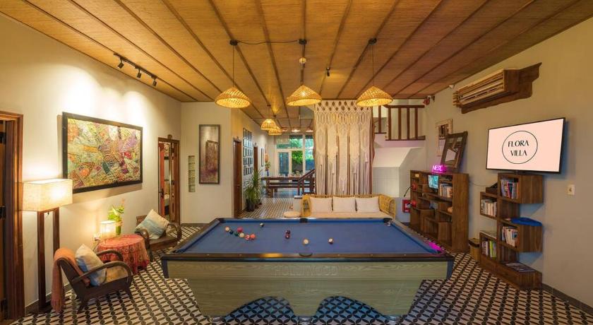 a living room filled with furniture and a pool, Flora Villa Hoi an By NEST in Hoi An
