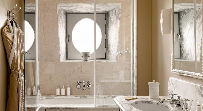 a bathroom with a sink, mirror and bath tub, Saint James Hotel Paris in Paris