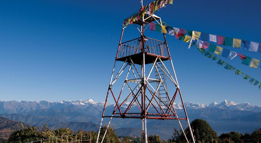 a tall tower with a clock on top, Hotel Country Villa in Nagarkot