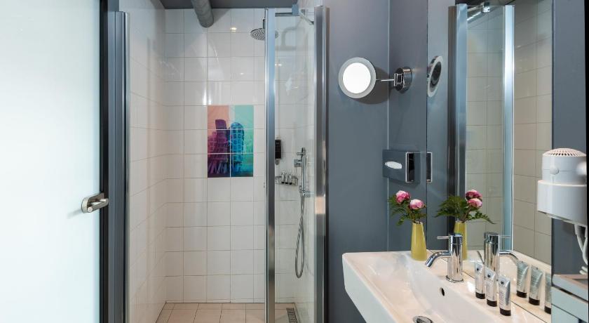a bathroom with a sink, mirror, and toilet, NYX Hotel Prague by Leonardo Hotels in Prague