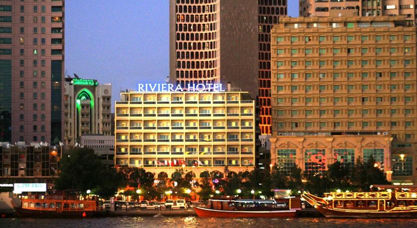 a city with lots of tall buildings and boats in the water, Riviera Hotel in Dubai