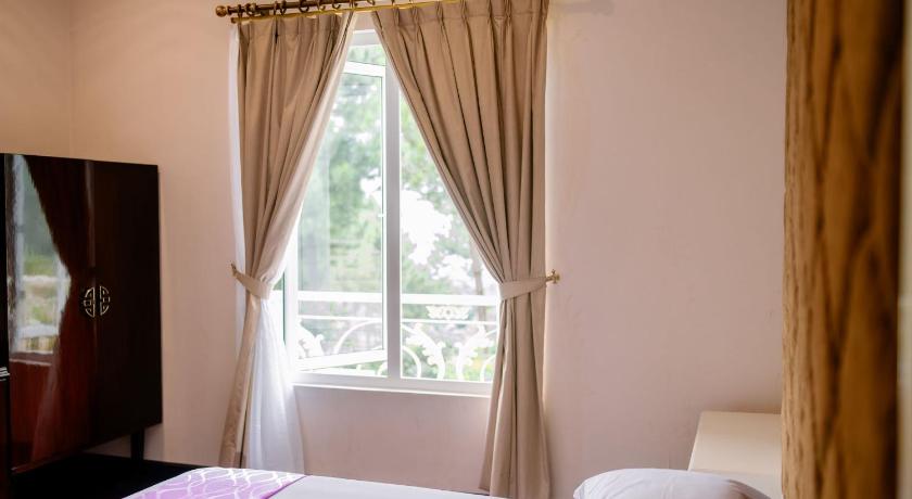 a bedroom with a white bedspread and a window, Beth Kasegaran Theresia in Puncak