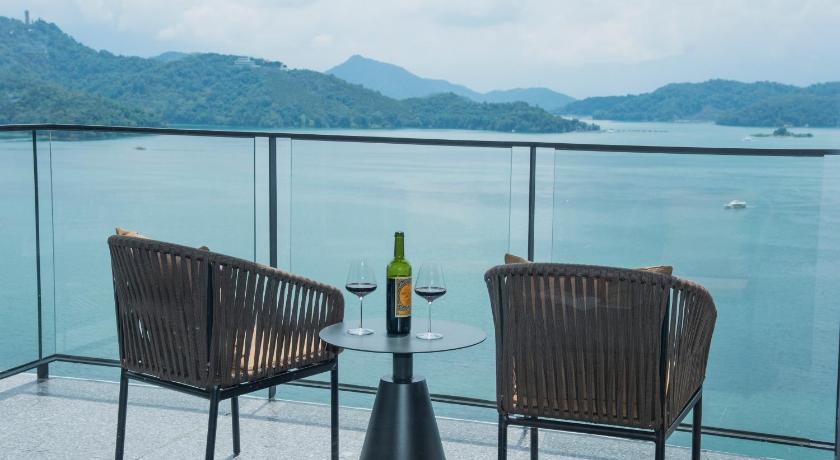 a wine glass sitting on top of a wooden table, Hotelday Sun Moon Lake Hotel in Nantou