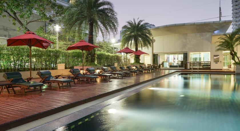 a patio area with tables and umbrellas, Centre Point Sukhumvit - Thong Lo Hotel in Bangkok