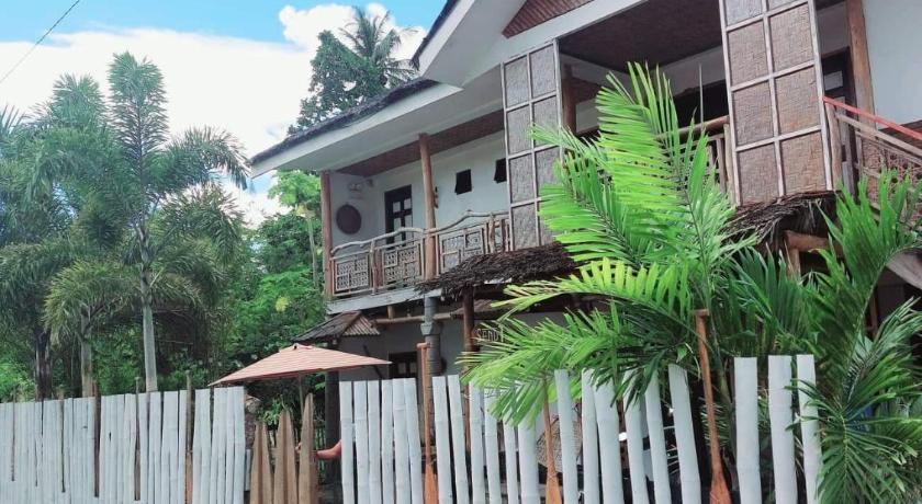 a house with a fence and a fence post, Sand 1 Hostel in Siquijor Island