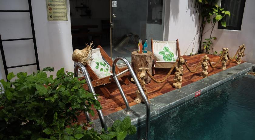 a living room with a pool table and chairs, Hoi An Fairy Garden Villa in Hoi An