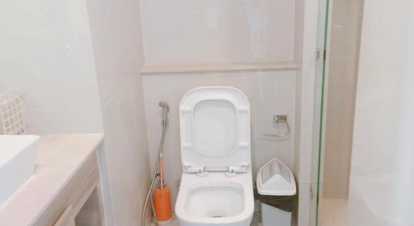 a white toilet sitting next to a bath tub, Riviera Jomtien by Hello Pattaya 1 in Pattaya