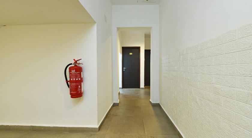 a red fire hydrant sitting in a hallway next to a wall, Capital O 90615 The Bed Hotel in Changlun