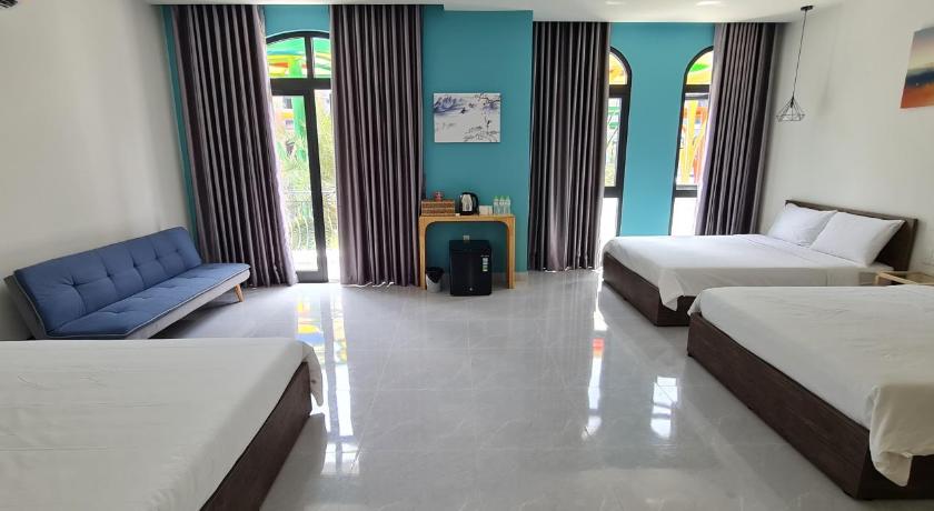 a hotel room with two beds and a television, BREAKING DAWN- TAEYANG Hotel Phu Quoc in Phú Quốc Island