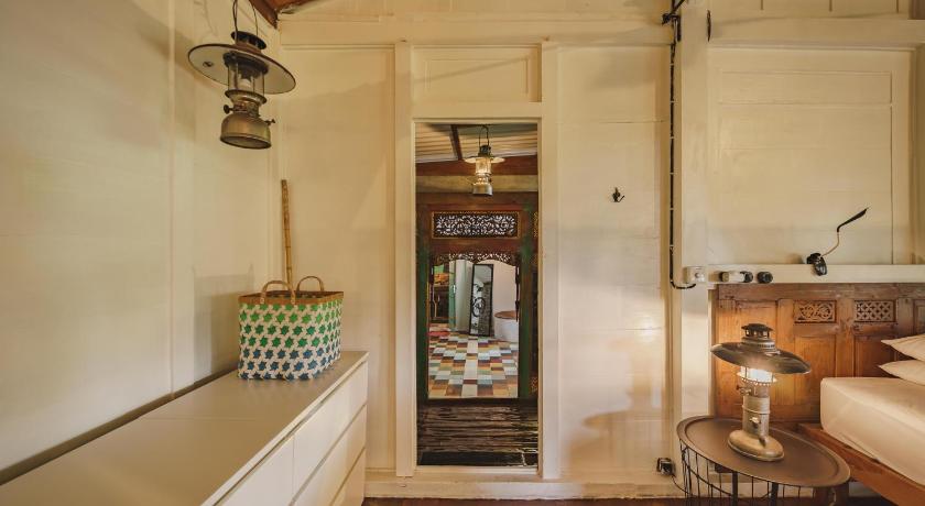 a kitchen with a refrigerator, stove, and sink, Rumah Jembarati by Sabda in Yogyakarta