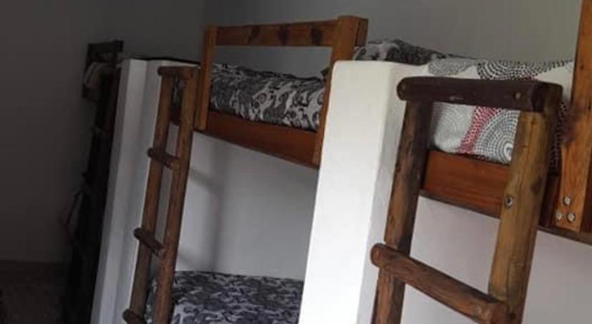 a bedroom with a bunk bed and a ladder, Jacobs Bay Backpackers in West Coast