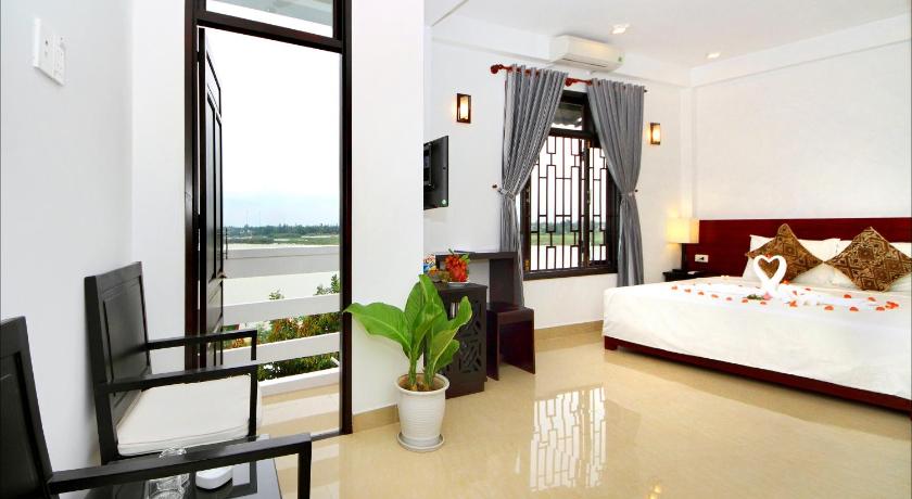 a hotel room with a view of the ocean, Riverlife Homestay Hoi An in Hoi An