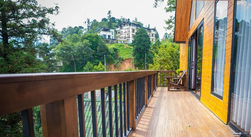 a wooden walkway leading to a balcony overlooking a forest, Sapa Pine Hill Ecolodge in Sapa