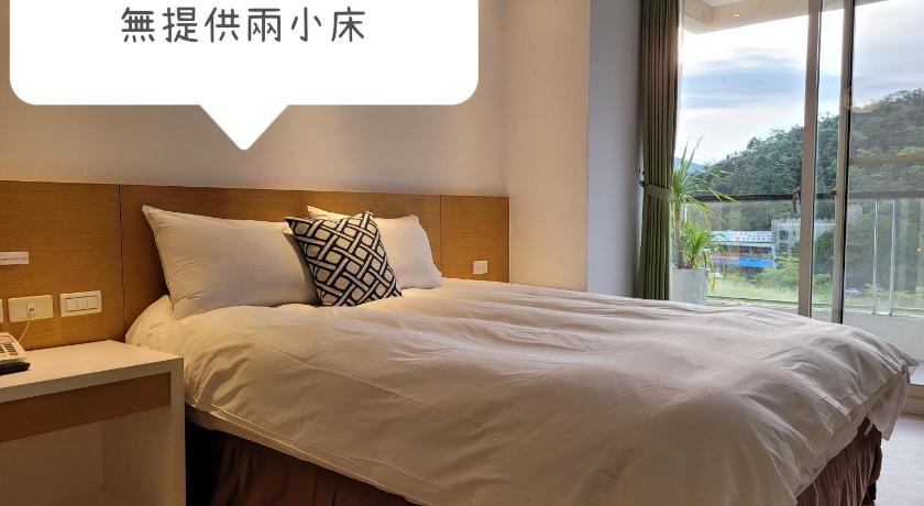 a hotel room with a bed and a window, Ze Hu B&B in Nantou