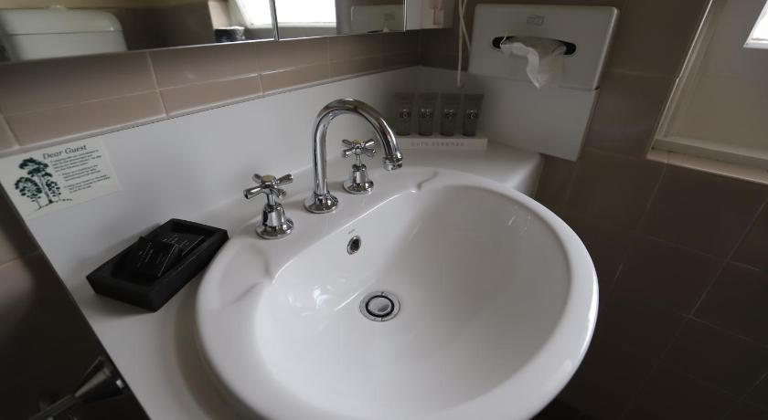 a bathroom with a sink and a mirror, Townhouse Motel Cowra in Cowra
