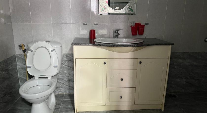 a white toilet sitting next to a sink in a bathroom, Bich Chau Hotel in Dalat