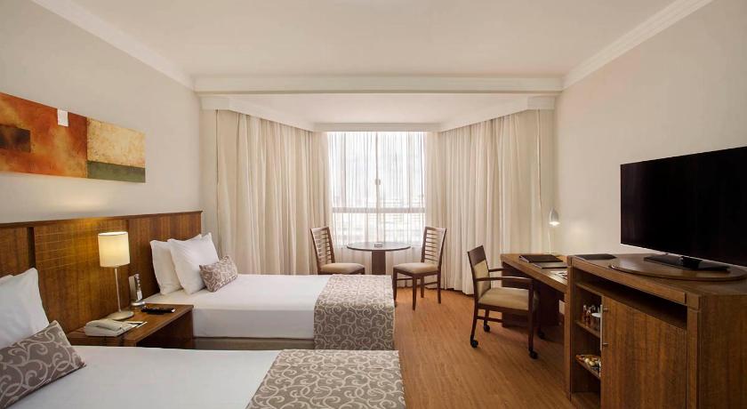 a hotel room with a bed and a television, Windsor Plaza Brasilia in Brasilia