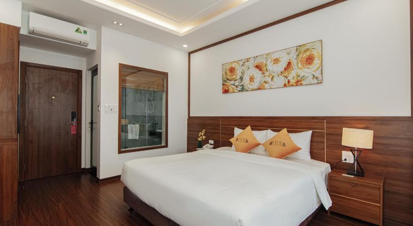 a hotel room with a bed and a desk, Jade Ha Long Hotel in Hạ Long