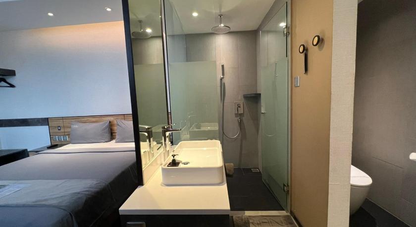 a hotel room with a double sink and a large mirror, Erian Hotel in Jakarta