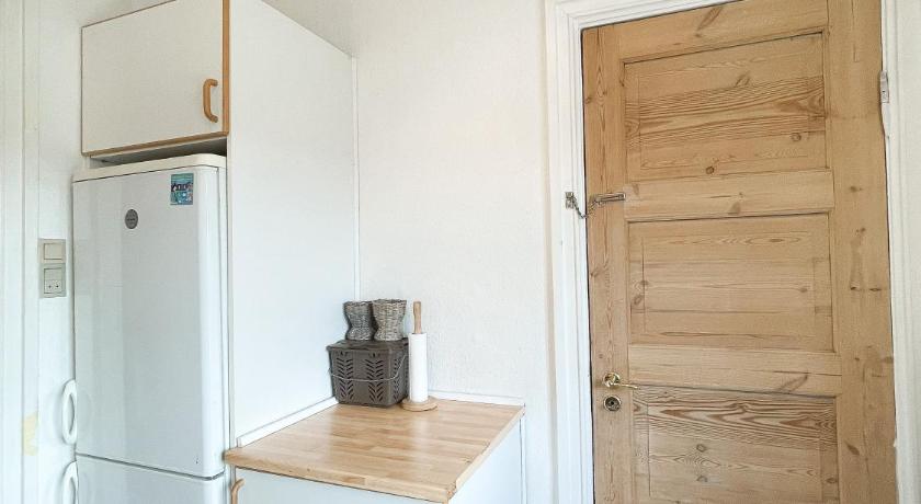 a kitchen with wooden cabinets and a refrigerator, Finlandsgade (ID 047) in Esbjerg