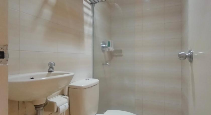 a bathroom with a toilet and a sink, The Abidin Hotel Syari'ah in Padang