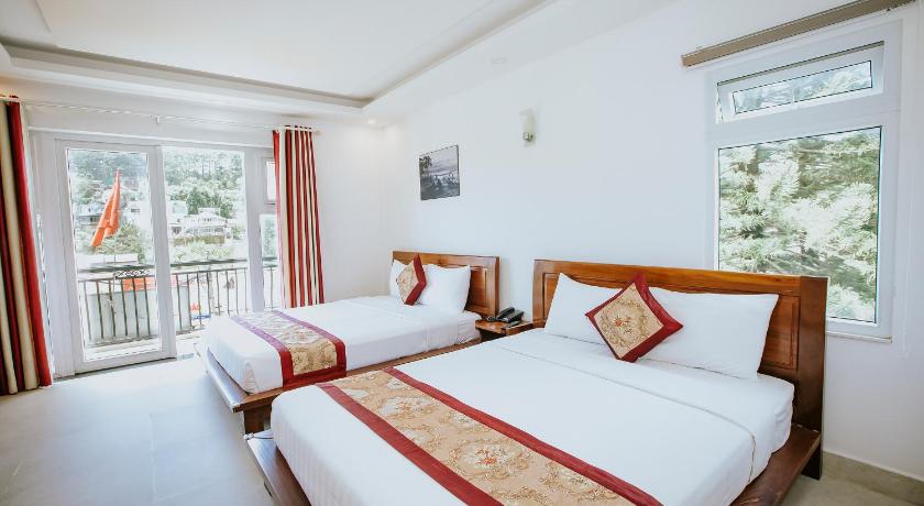 a hotel room with two beds and two windows, Lien Huong Hotel in Dalat