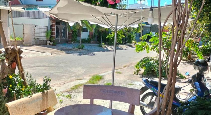 a table and chairs in a garden area, Homestay Bao Tran in Phan Thiet