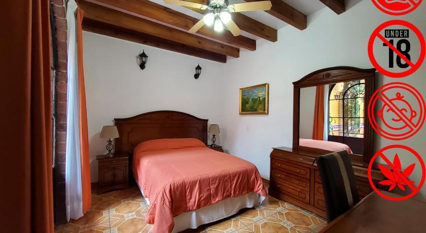a bedroom with a large bed and a large window, Villa Alfonsina in Mexico City
